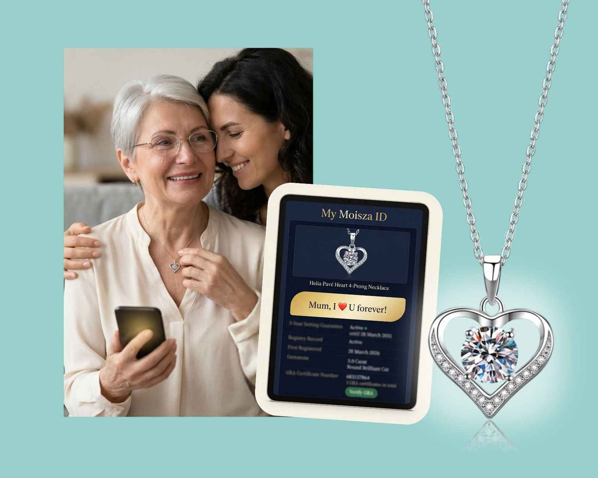 Mother smiling in happy tears beside her daughter, wearing the Helia Pavé Heart necklace, holding a phone on her hand, with her Moisza ID message separately shown on an iPad.